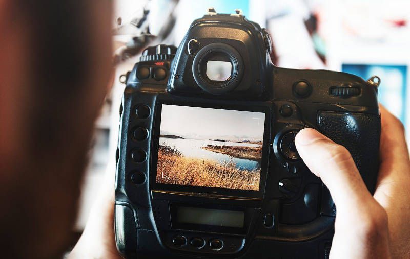 A person is taking a picture with a camera.