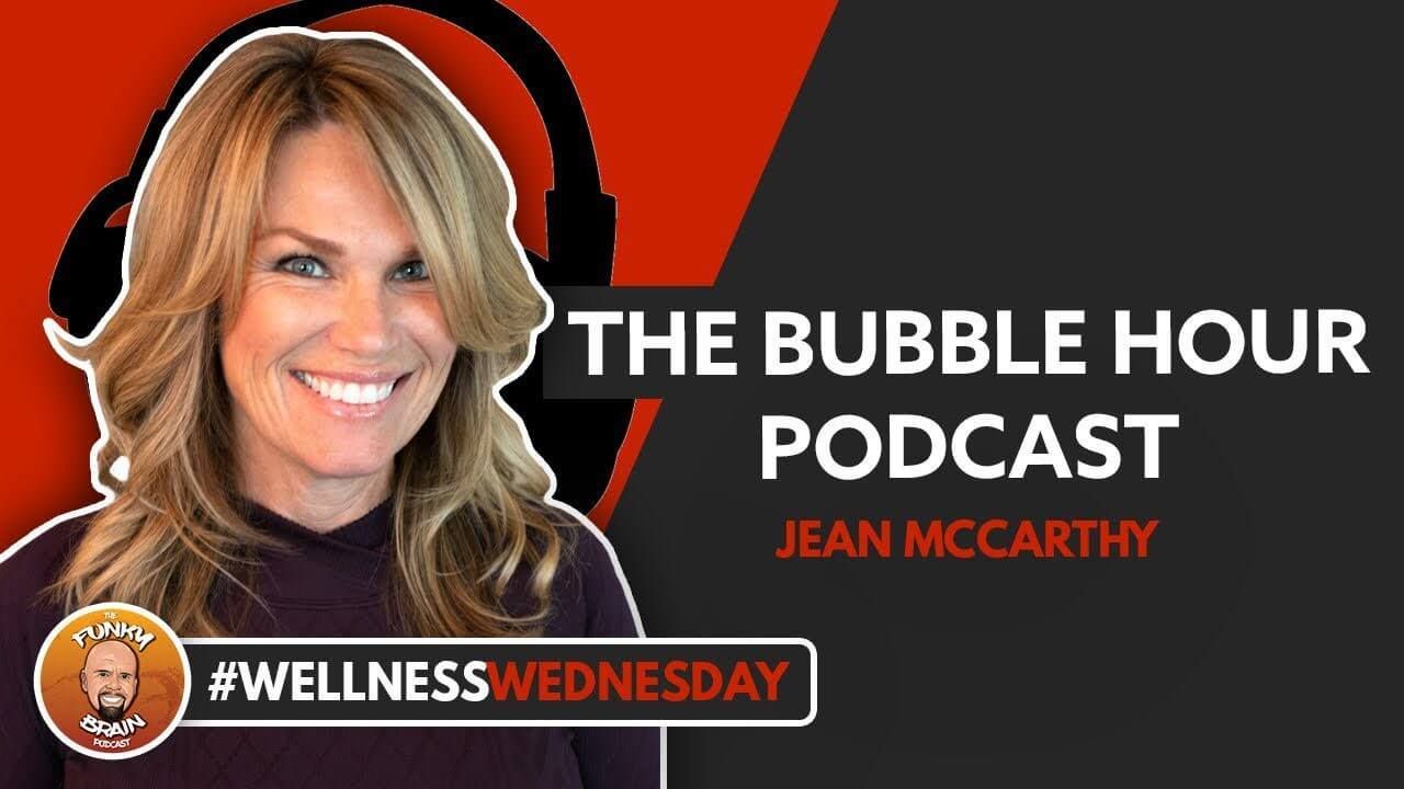 A woman is wearing headphones and smiling for the bubble hour podcast.