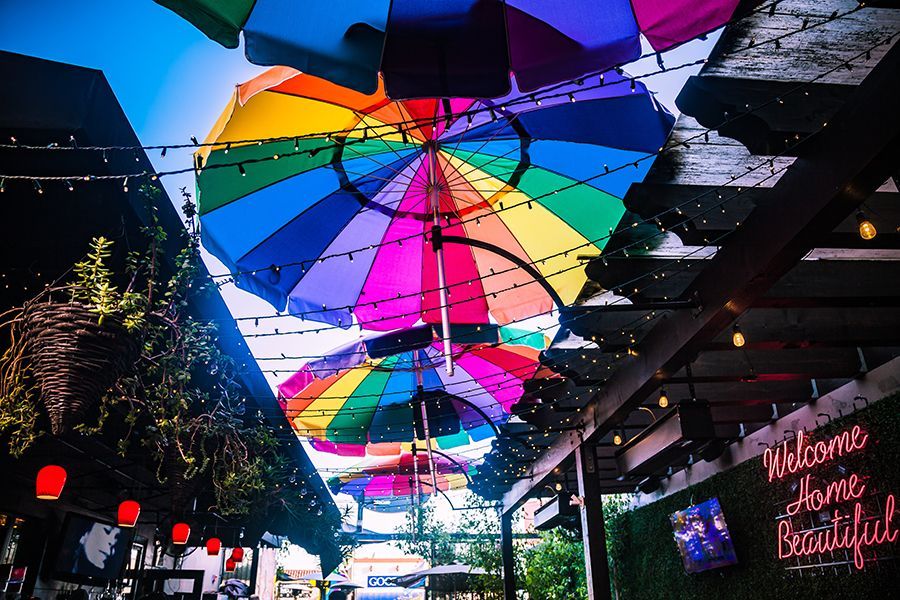 A rainbow colored umbrella is hanging from the ceiling