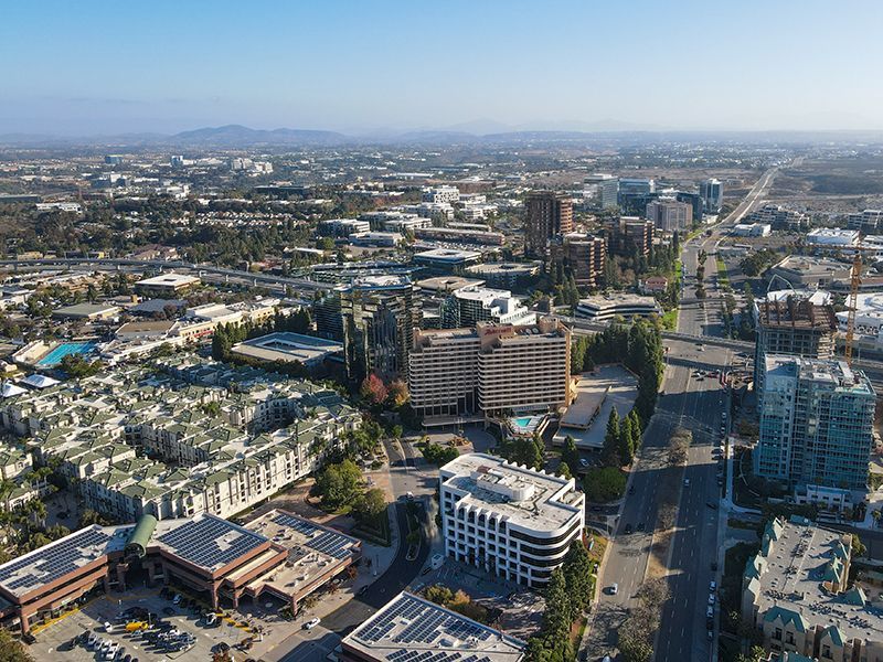 An aerial view of a city with lots of buildings and trees.