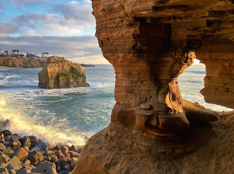 There is a large rock in the middle of the ocean.