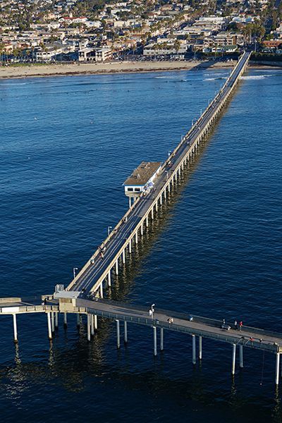 An aerial view of a long pier over a body of water.