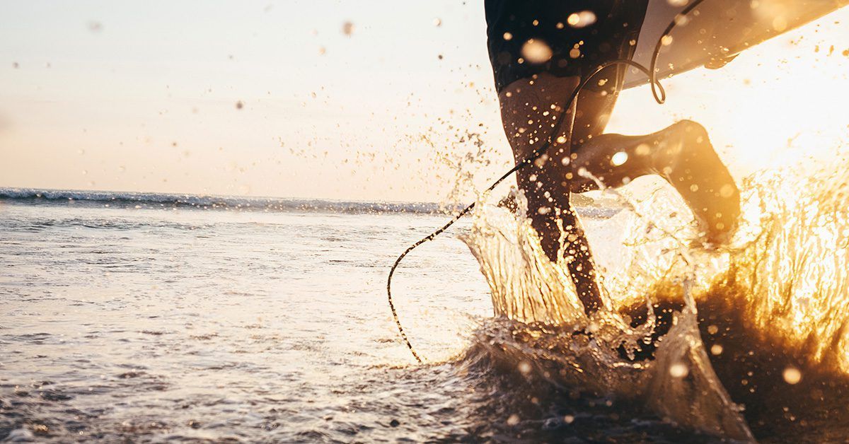 A person is riding a wave on a surfboard in the ocean.