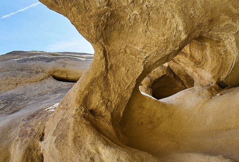 A close up of a rock formation with a blue sky in the background