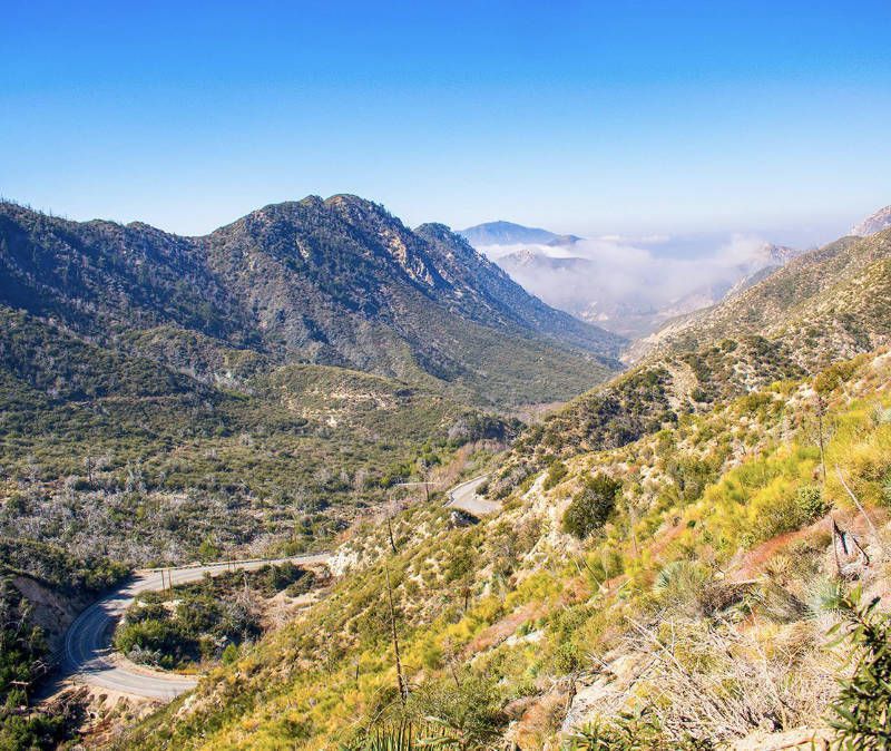 A view of a mountain range with a road going through it.