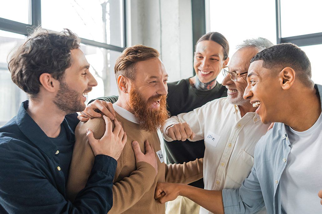 A group of men are hugging each other in a room.