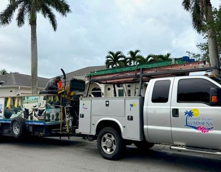 A utility truck with a trailer attached to it is parked on the side of the road.