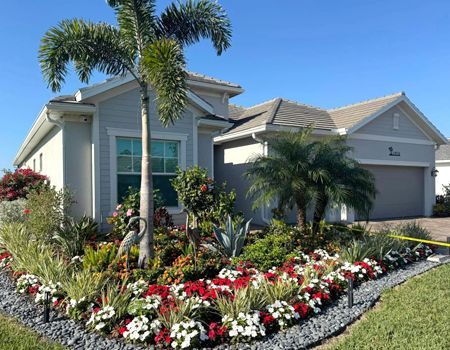 A house with a lot of flowers in front of it