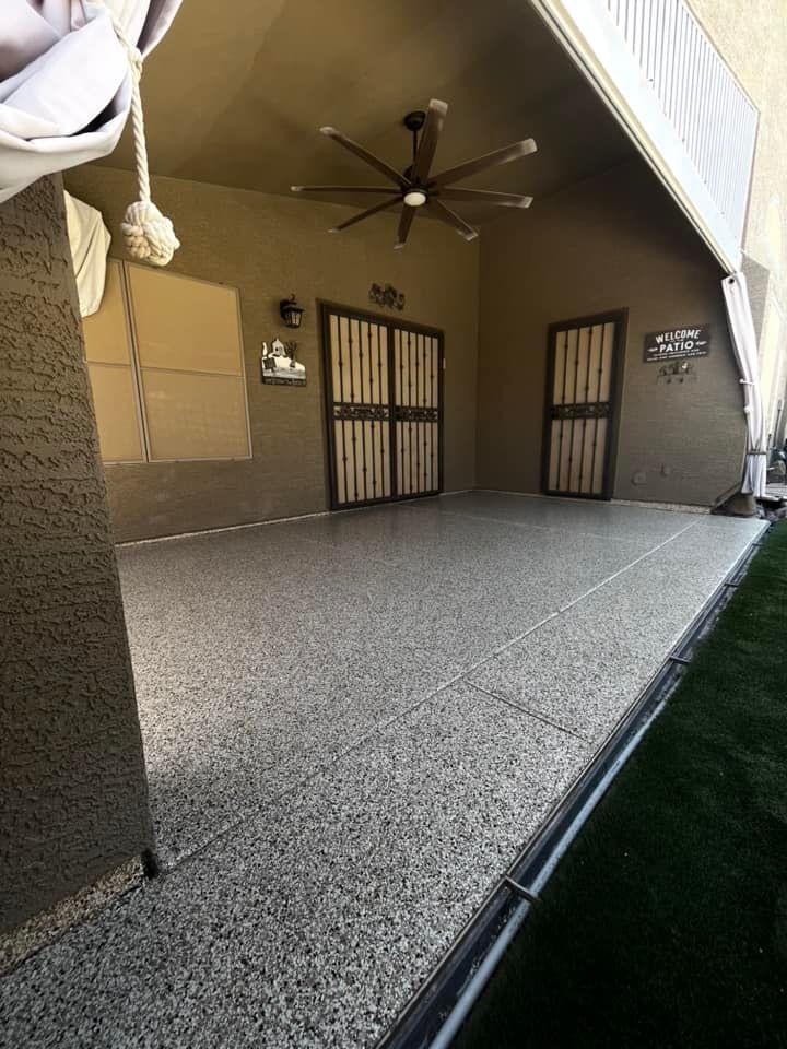 A patio with a ceiling fan and a sliding glass door.