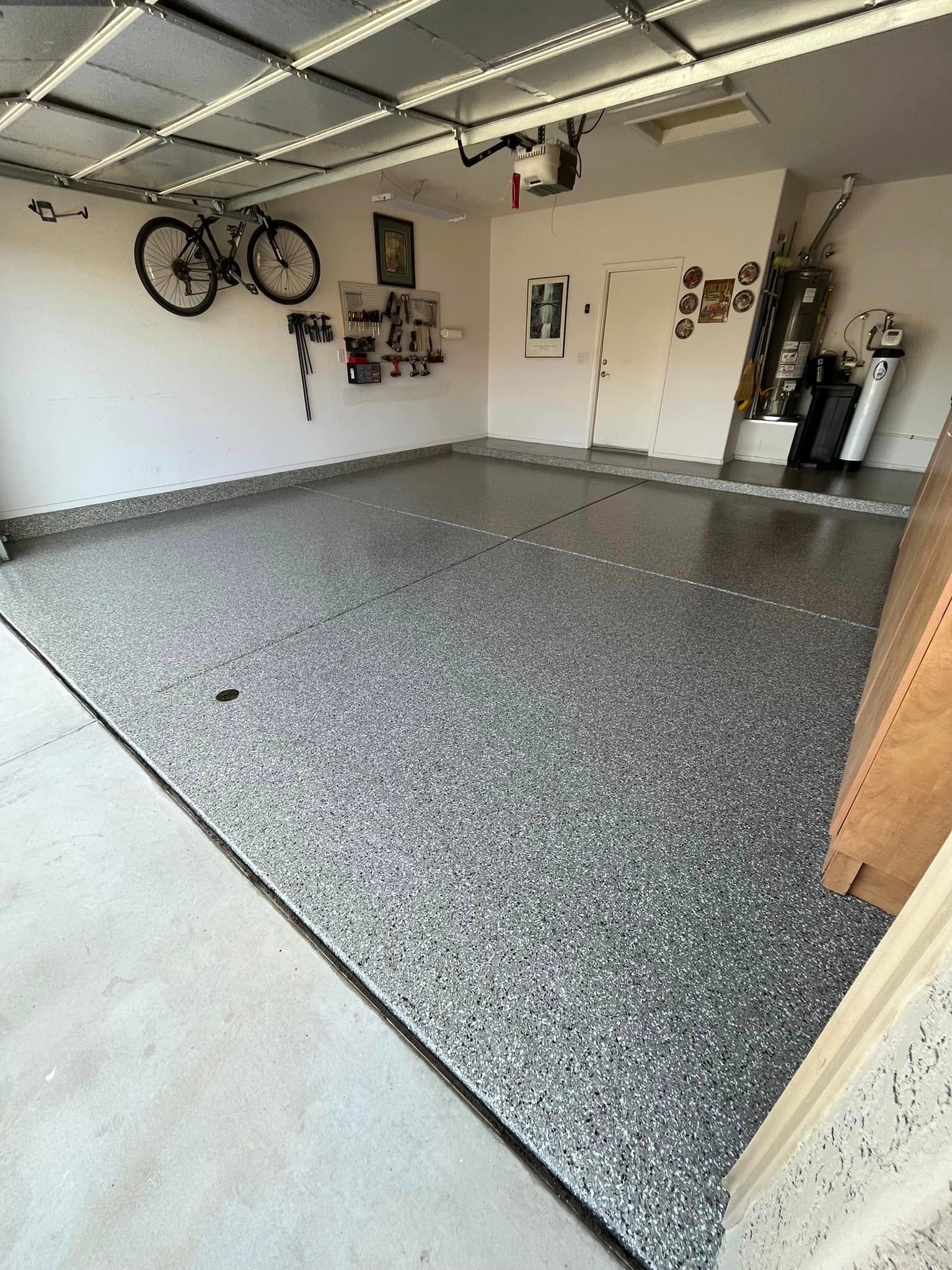 A garage with a bicycle hanging on the wall.