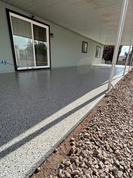 A porch with a concrete floor and a sliding glass door.
