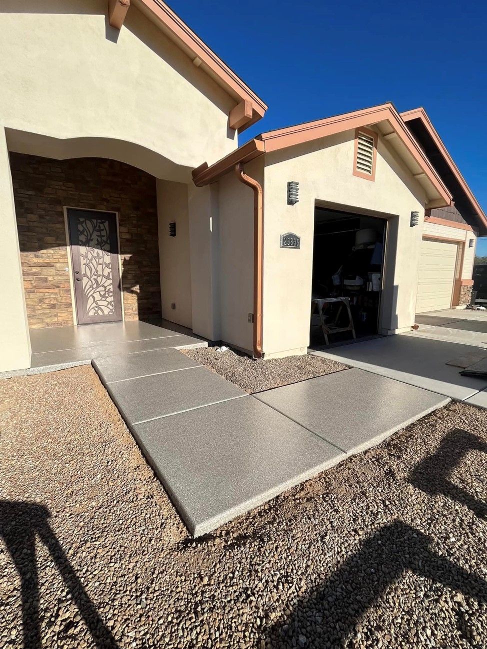A house with a garage and a walkway leading to it