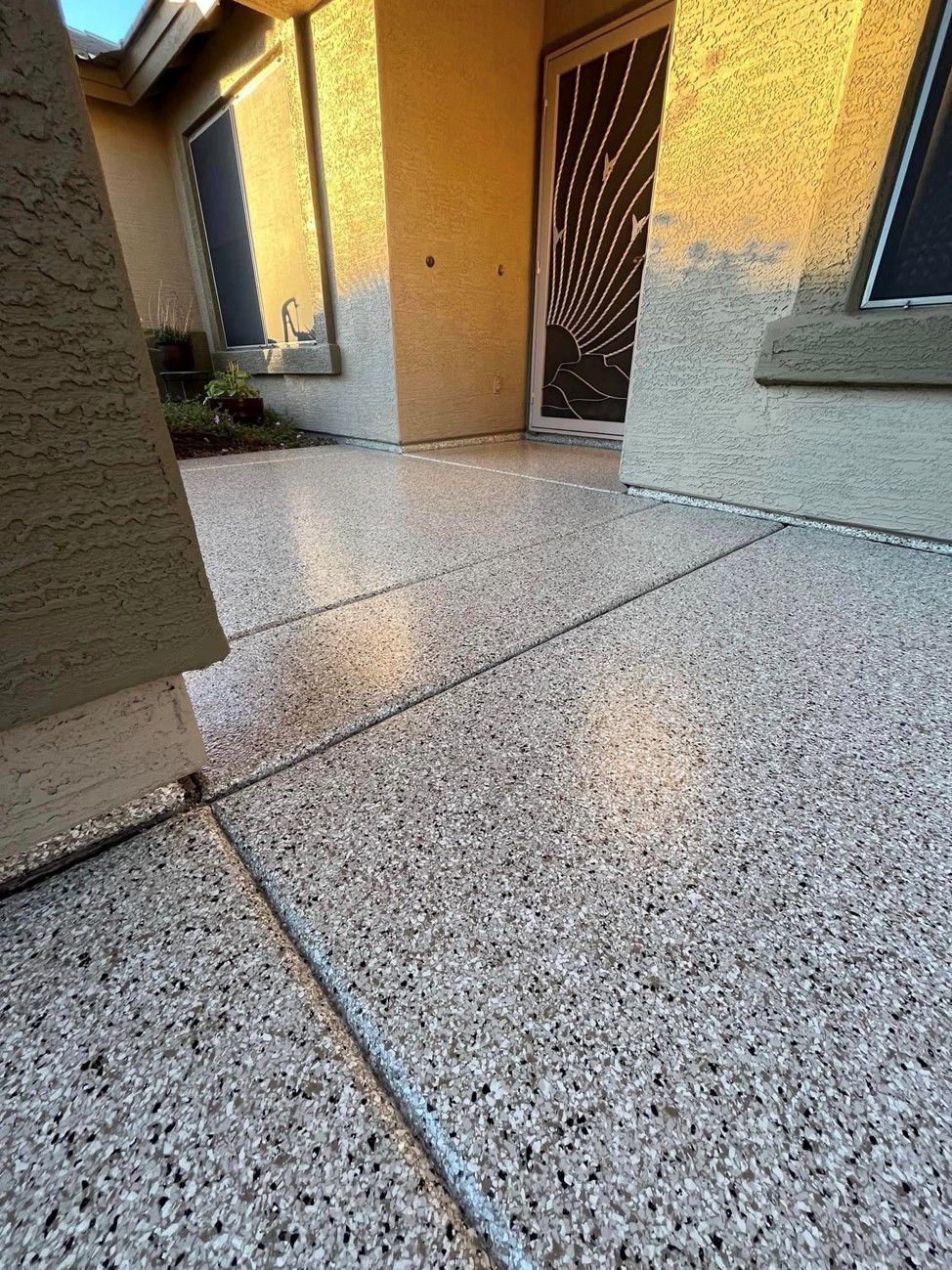 A close up of a concrete floor in front of a house.