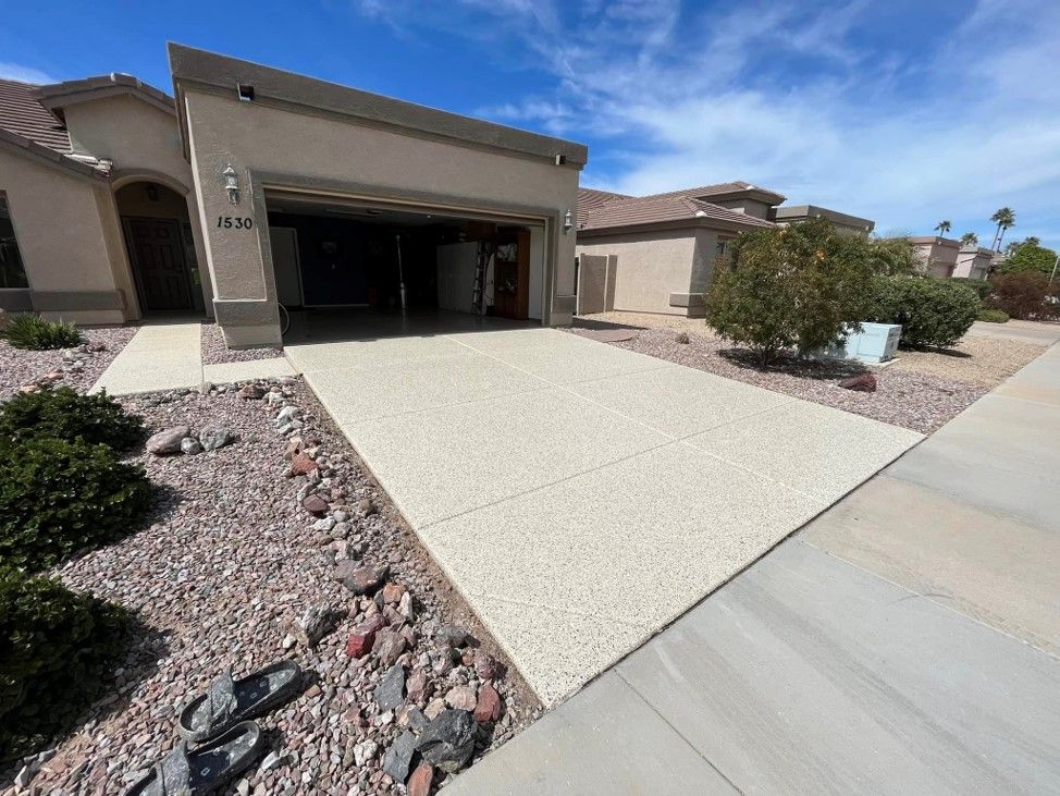 A driveway leading to a house with a garage.