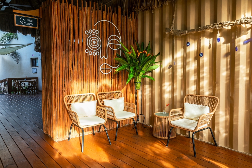 Waiting area with wicker chairs, wood walls, and decorative eye art.