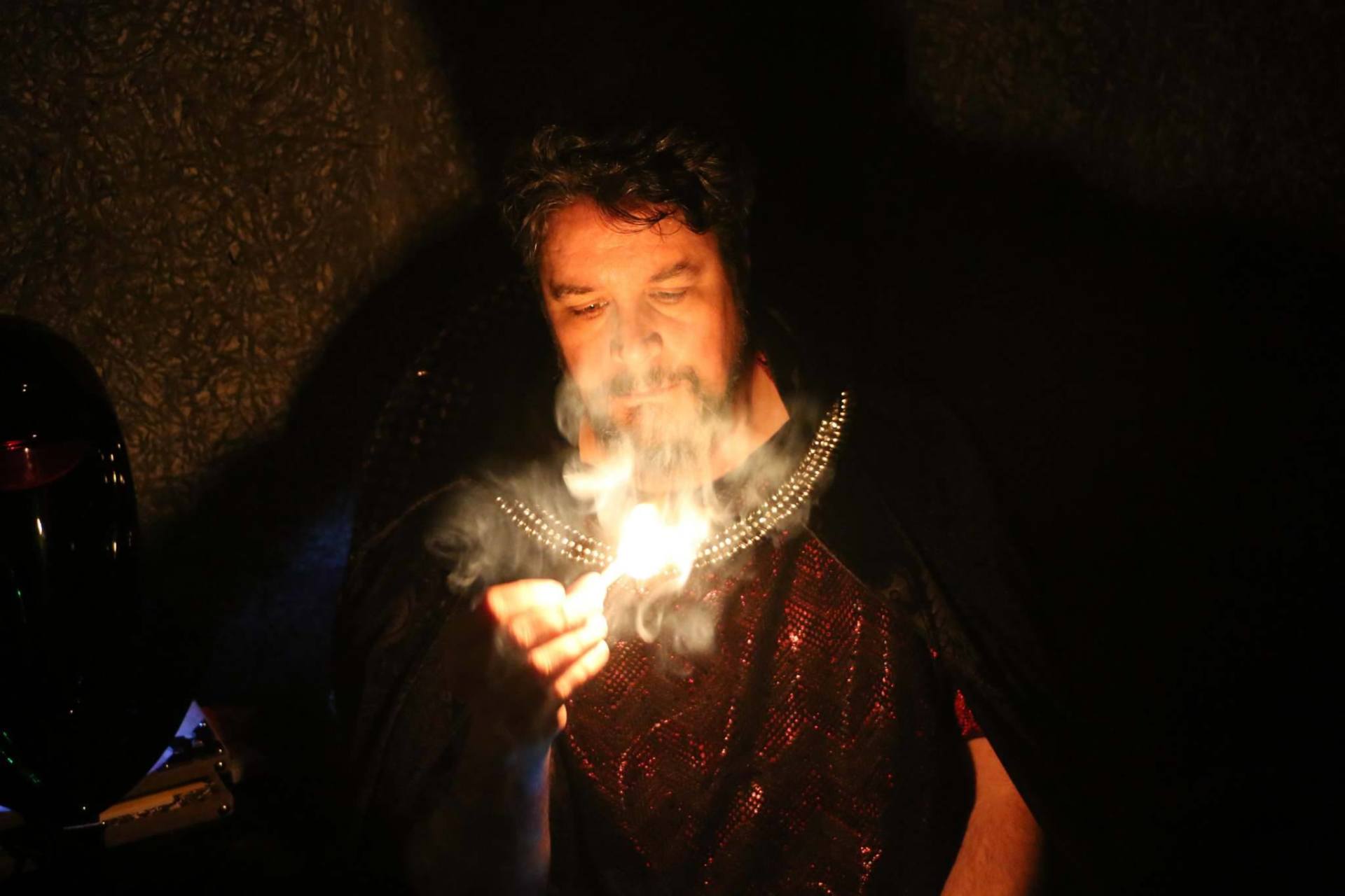 a man holding fire representing Hades.