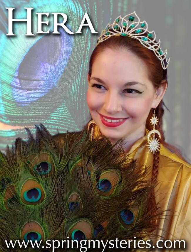 A woman wearing a peacock feather crown and earrings, Titania Thunderlily representing Hera