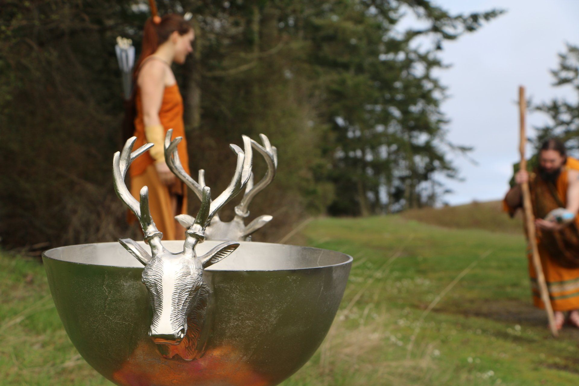 A metal bowl with a deer head on it