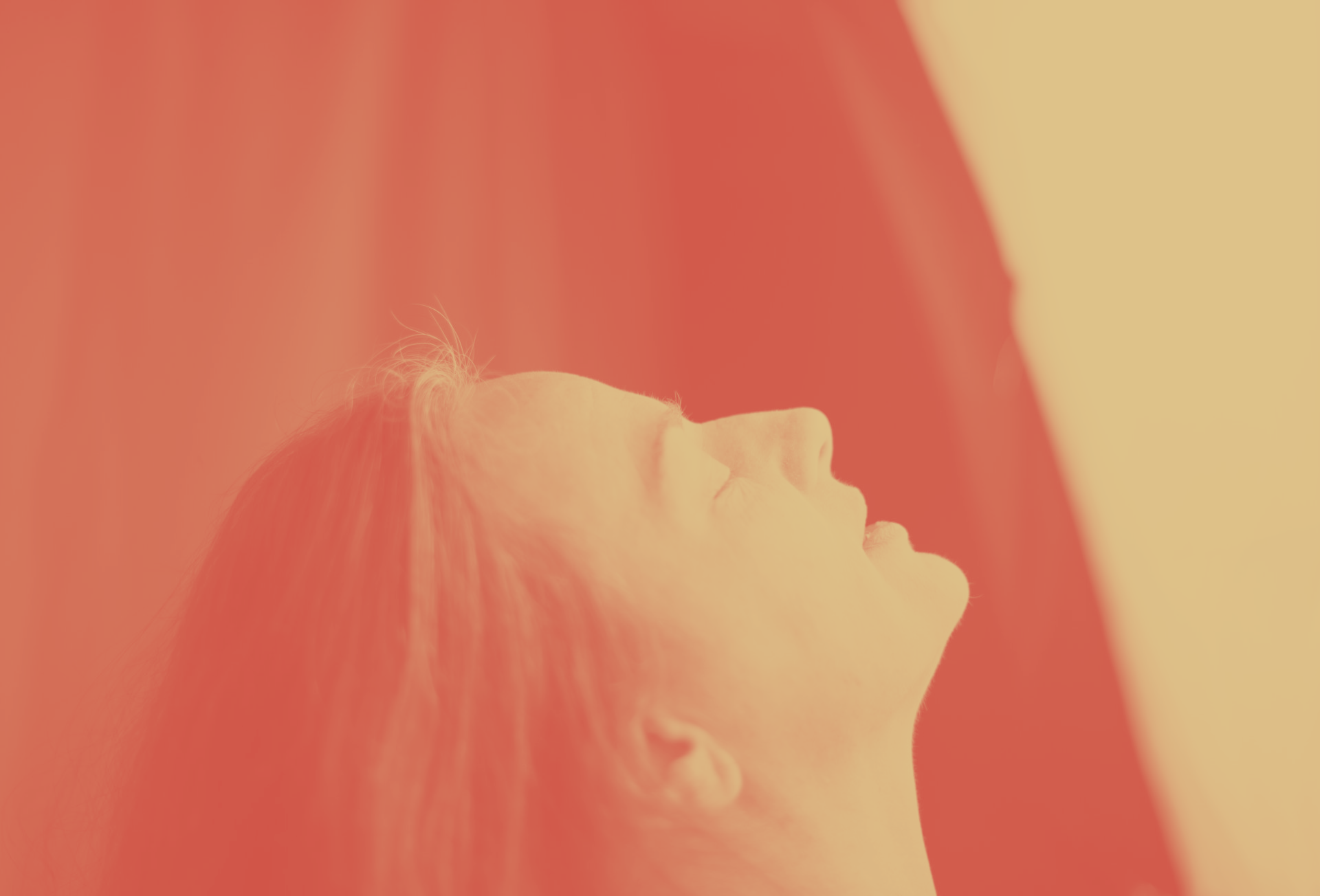 A woman is looking up at the sky with her eyes closed, Isidora LaVeau representing Baubo.