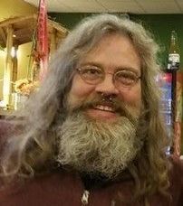 A man with a tattoo of the letter x on his face