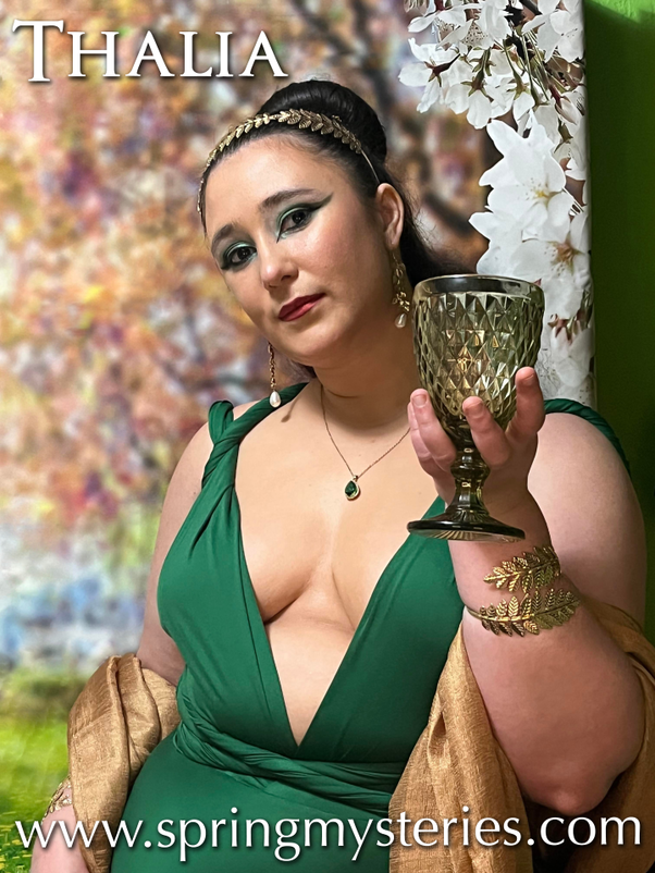 A woman in a green dress is holding a wine glass, Raven Wolfenone