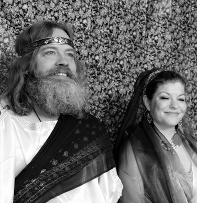 A man next to a woman in a black and white photo, Michael Alling, representing Zeus and Hera.