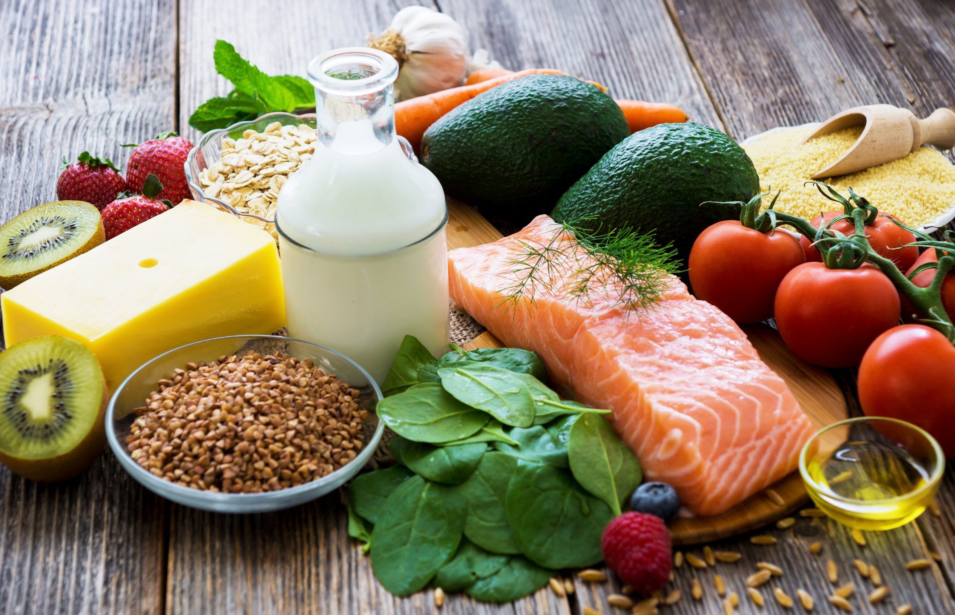a wooden table topped with a variety of healthy foods .