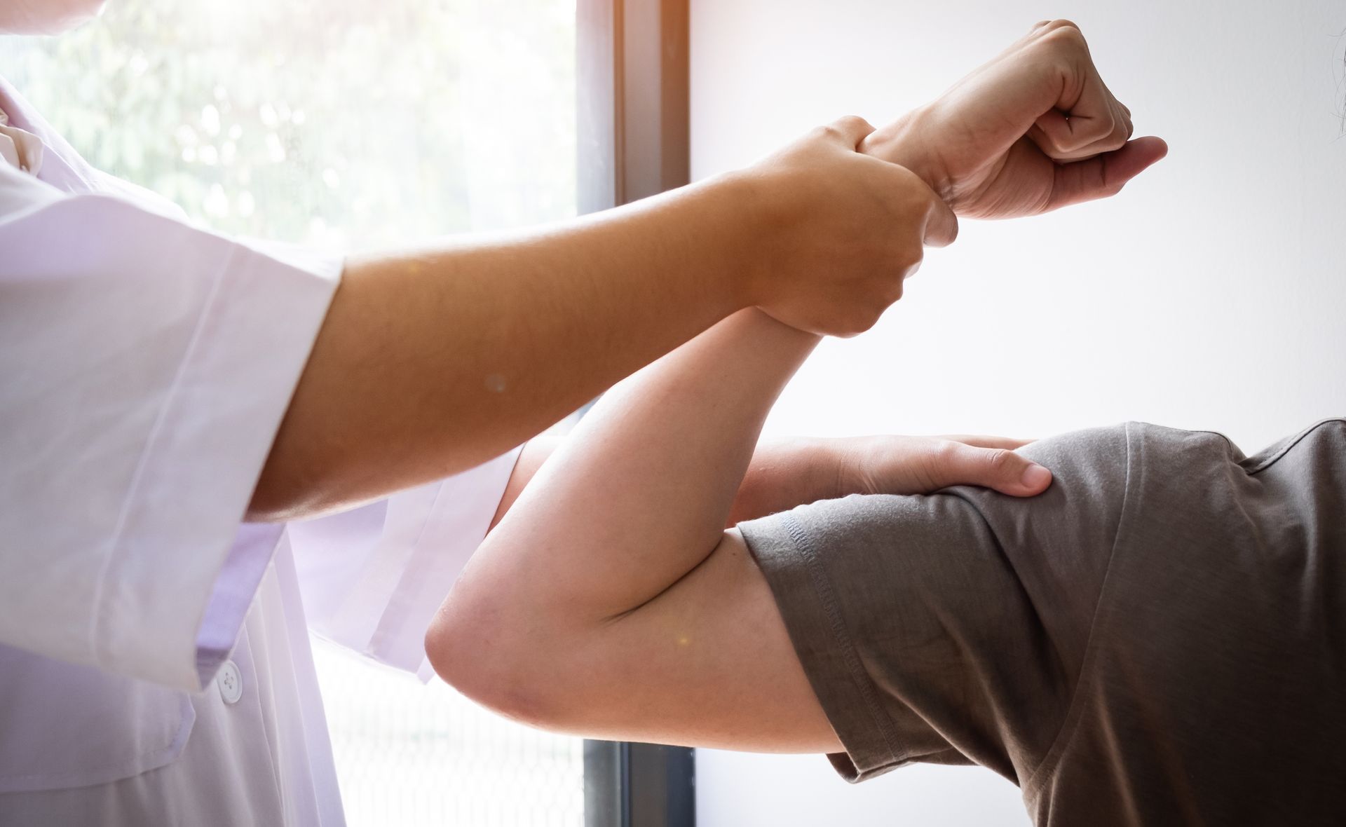 a person is getting their arm examined by a doctor .