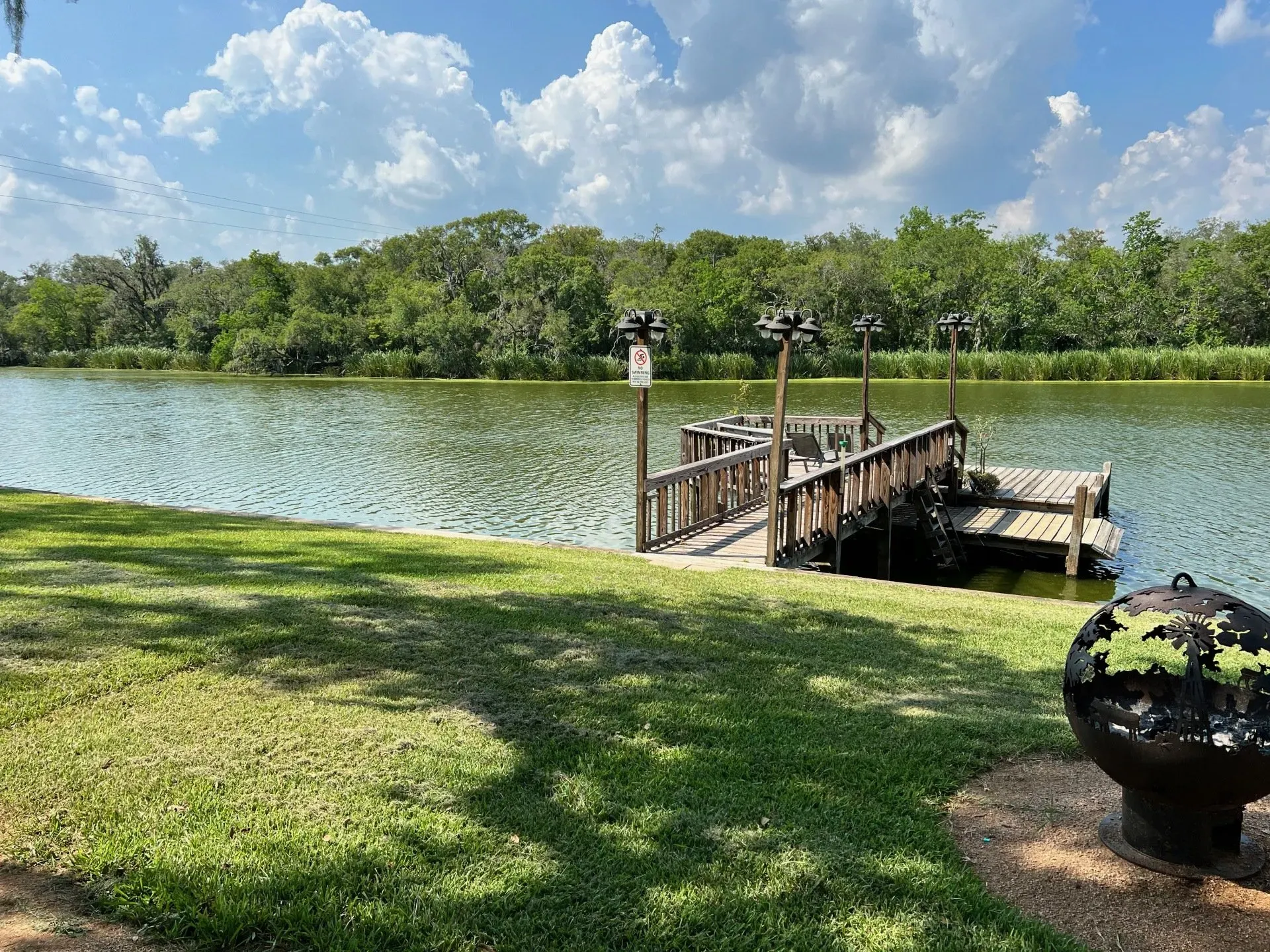 there is a dock in the middle of a lake .