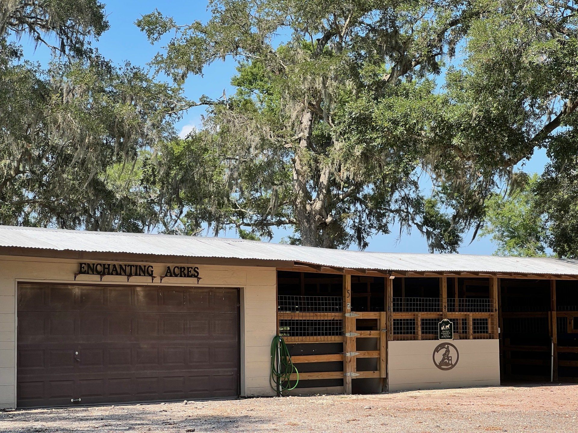 a garage with a sign that says enchanting acres