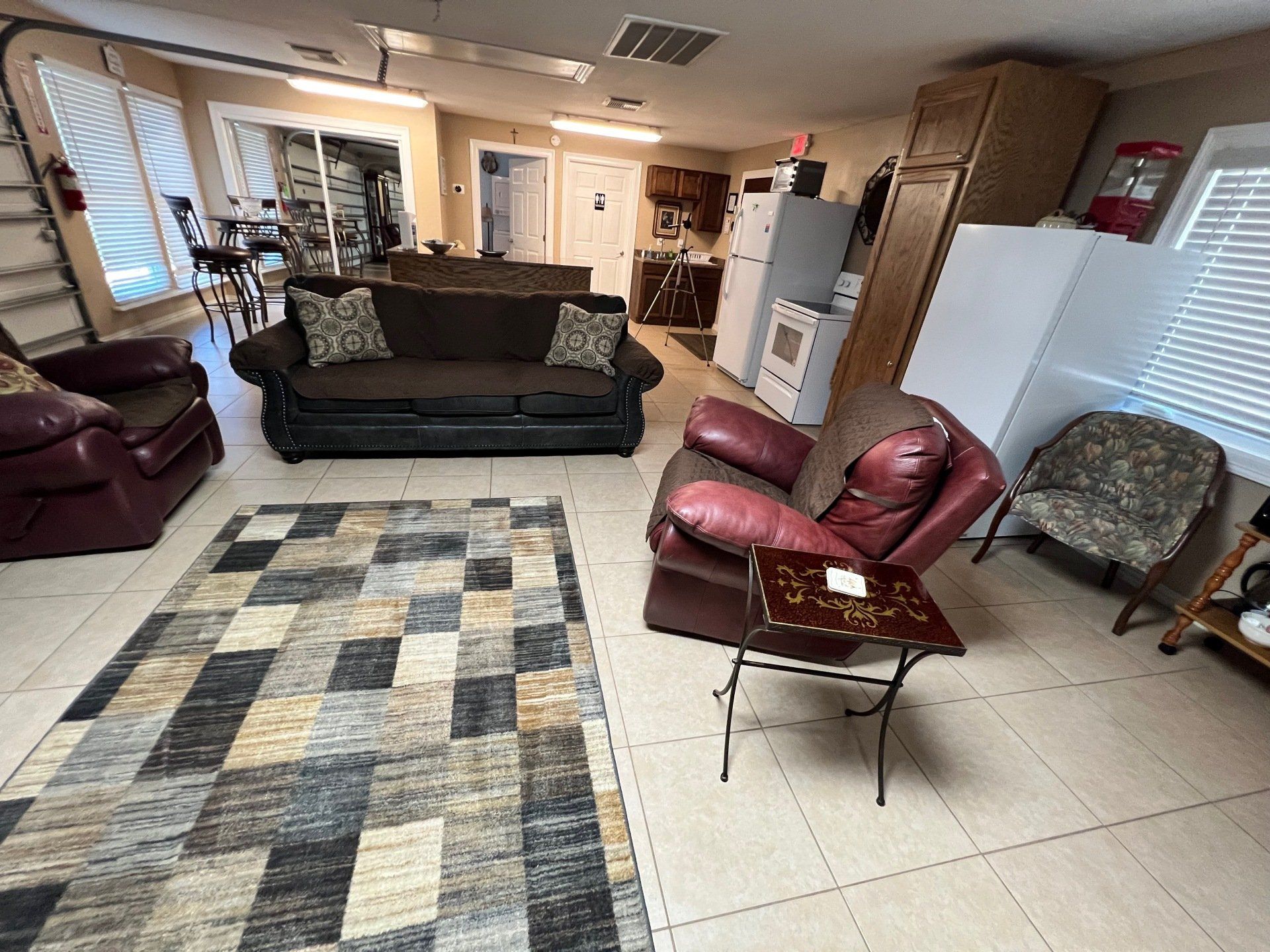 a living room with a couch , chairs , and a rug