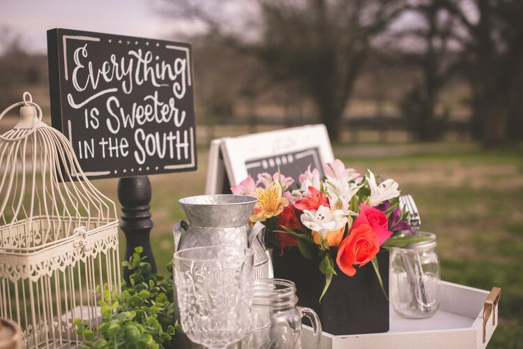 a table with a sign that says `` everything is sweeter in the south '' .