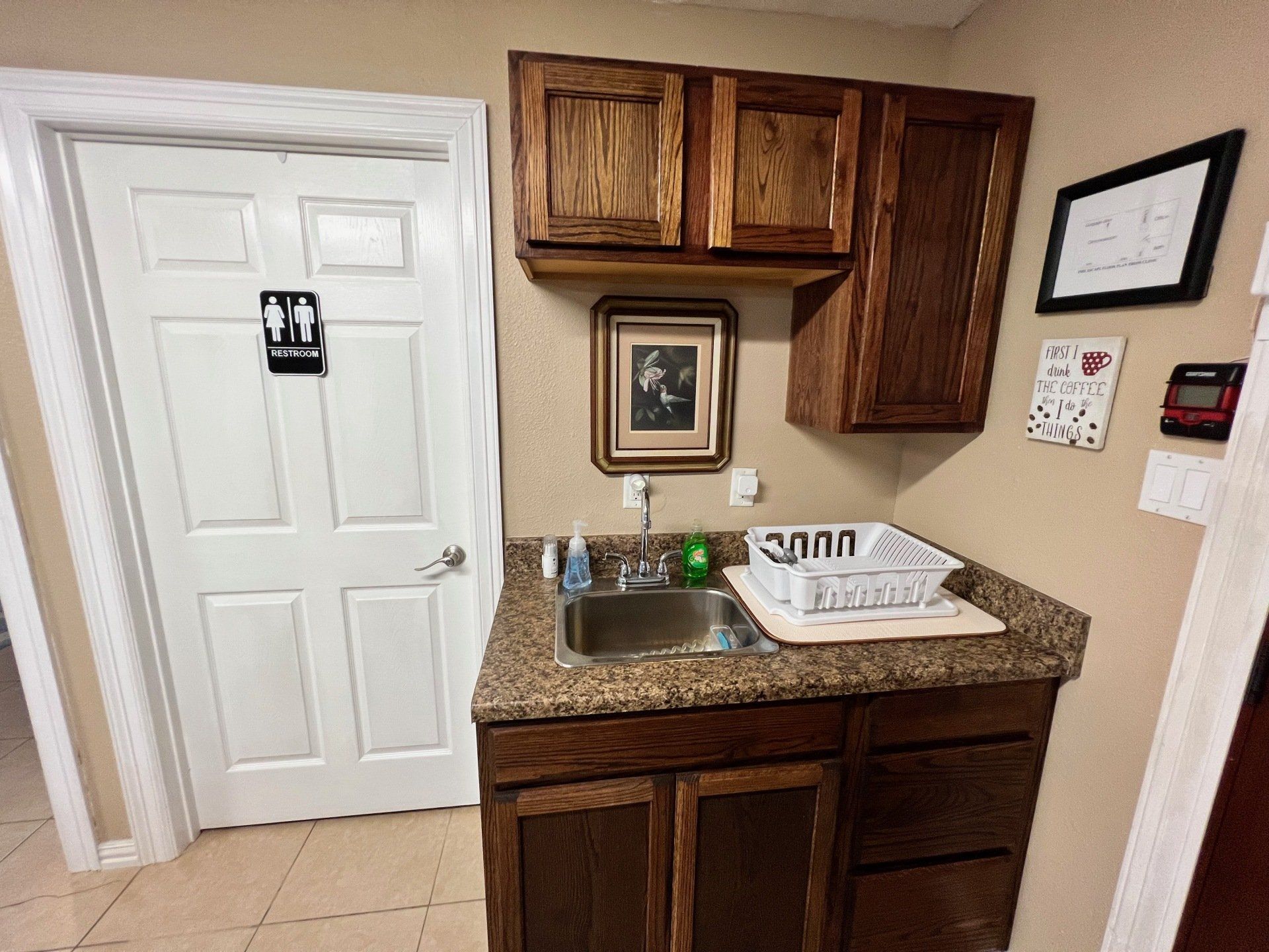 a kitchen with a sink , cabinets , and a door .