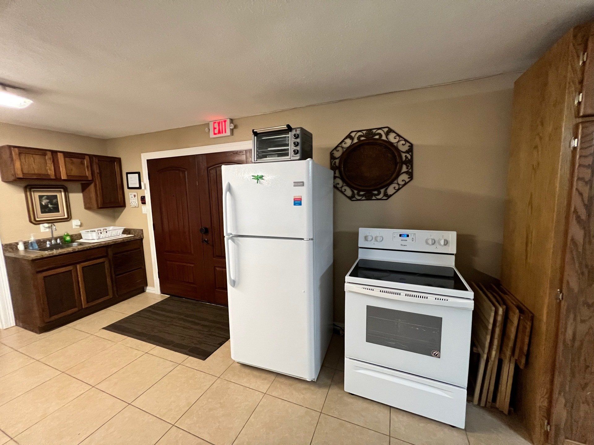 a kitchen with a refrigerator , stove and microwave .