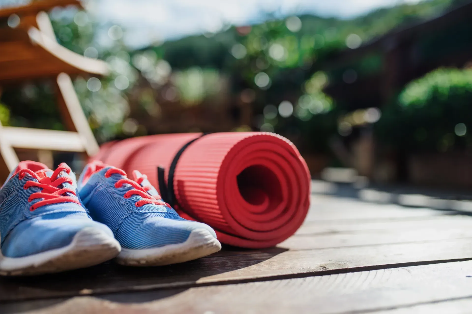 blue running shoes, pink yoga mat outdoors