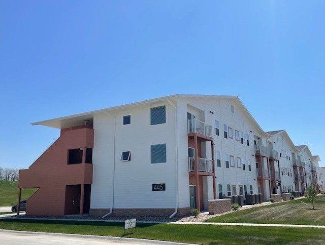 A large apartment building with a sign on the side that says 1326