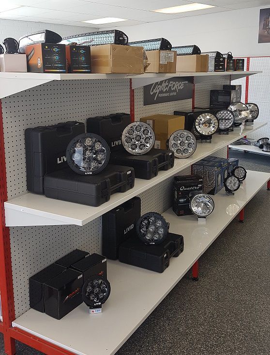A Store Shelf With A Lot Of Lights On It — Autofit88 Auto Electrics In Ciccone, NT