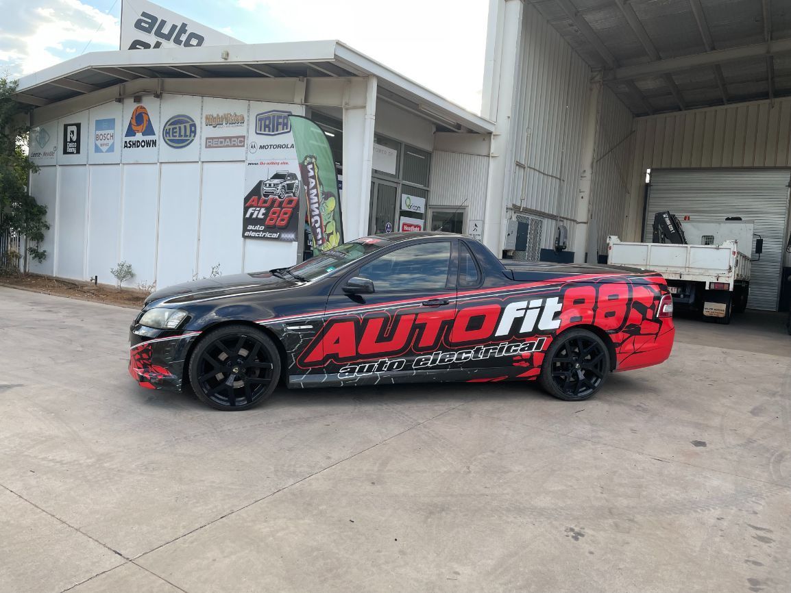 A Black And Red Car Is Parked In Front Of A Building — Autofit88 Auto Electrics In Ciccone, NT