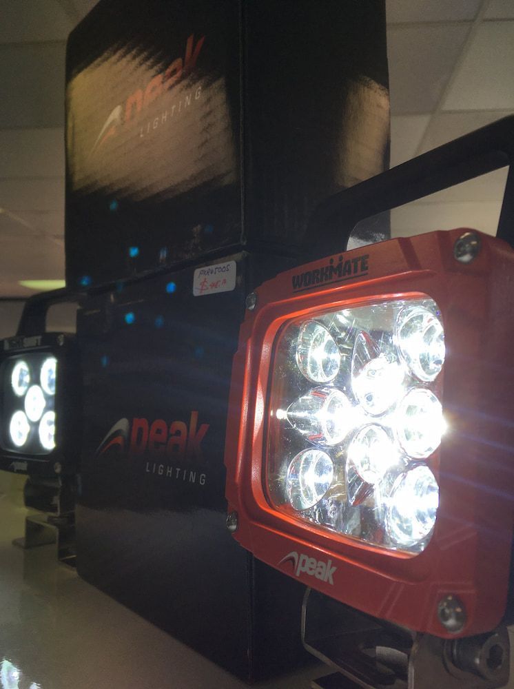 A Red Apeak Light is Sitting on a Table Next to a Black Box — Autofit88 Auto Electrics In Ciccone, NT