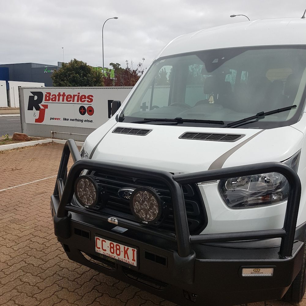 A White Van is Parked in Front of a Sign That Says Batteries — Autofit88 Auto Electrics In Ciccone, NT