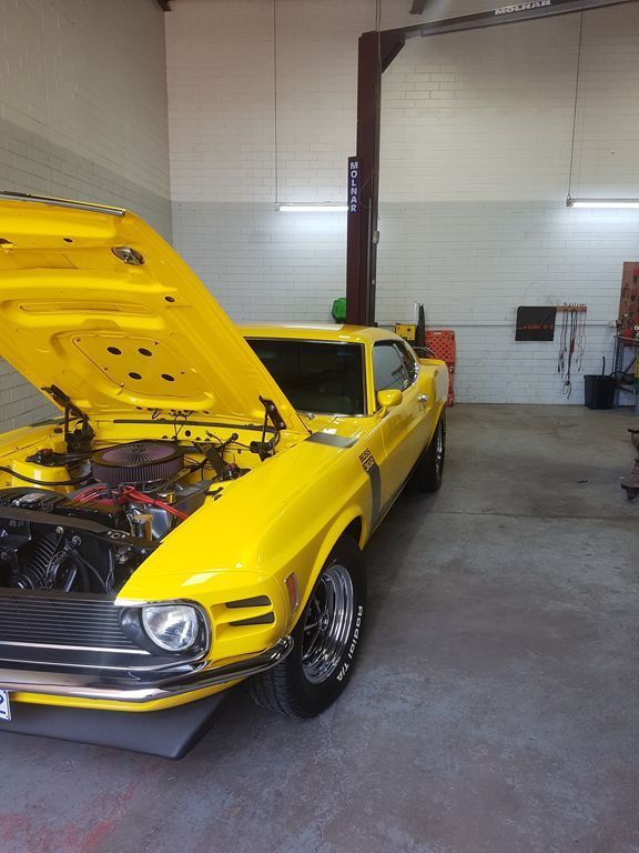 A Yellow Mustang With The Hood Up In A Garage — Autofit88 Auto Electrics In Ciccone, NT
