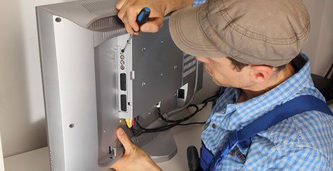 D & L Electronic Repairs electrician repairing a TV
