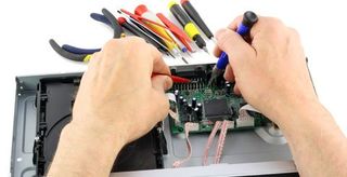 D & L Electronic Repairs technician repairs a DVD player