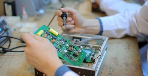 D & L Electronic Repairs technician repairing a microcircuit