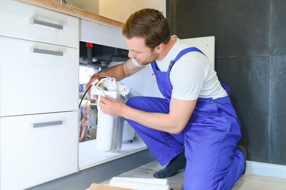 plumber installing water filter