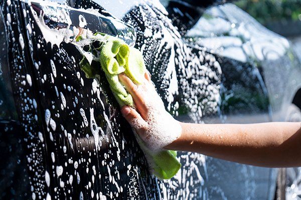Close-Up Hands Car Hand Washing — Issaquah, WA — David’s Auto Detailing