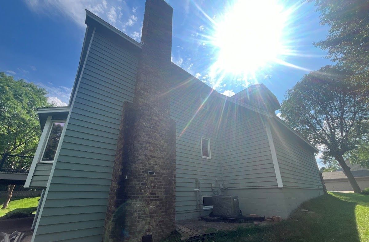 The sun is shining brightly on the side of a house.