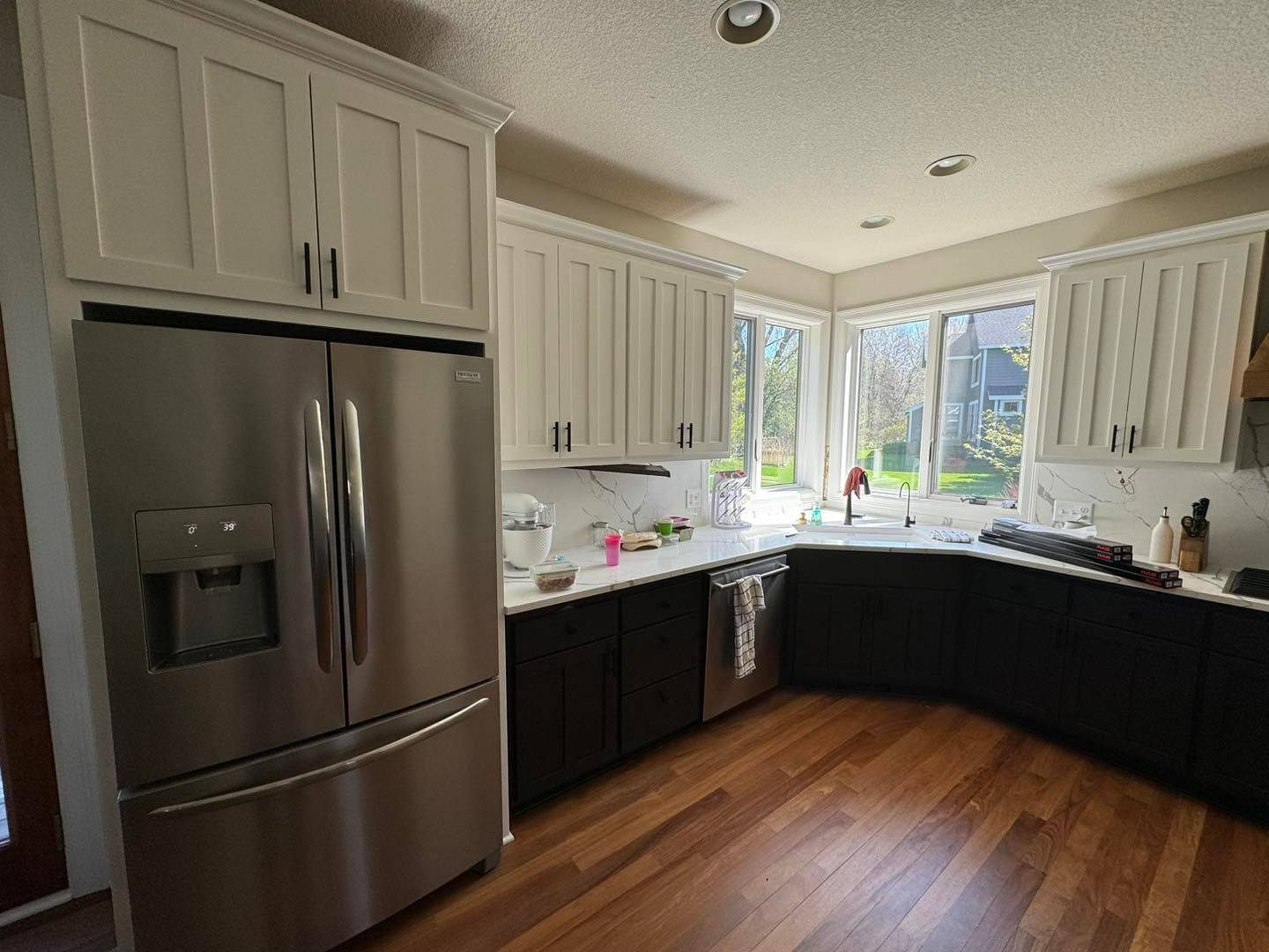 A kitchen with stainless steel appliances and white cabinets
