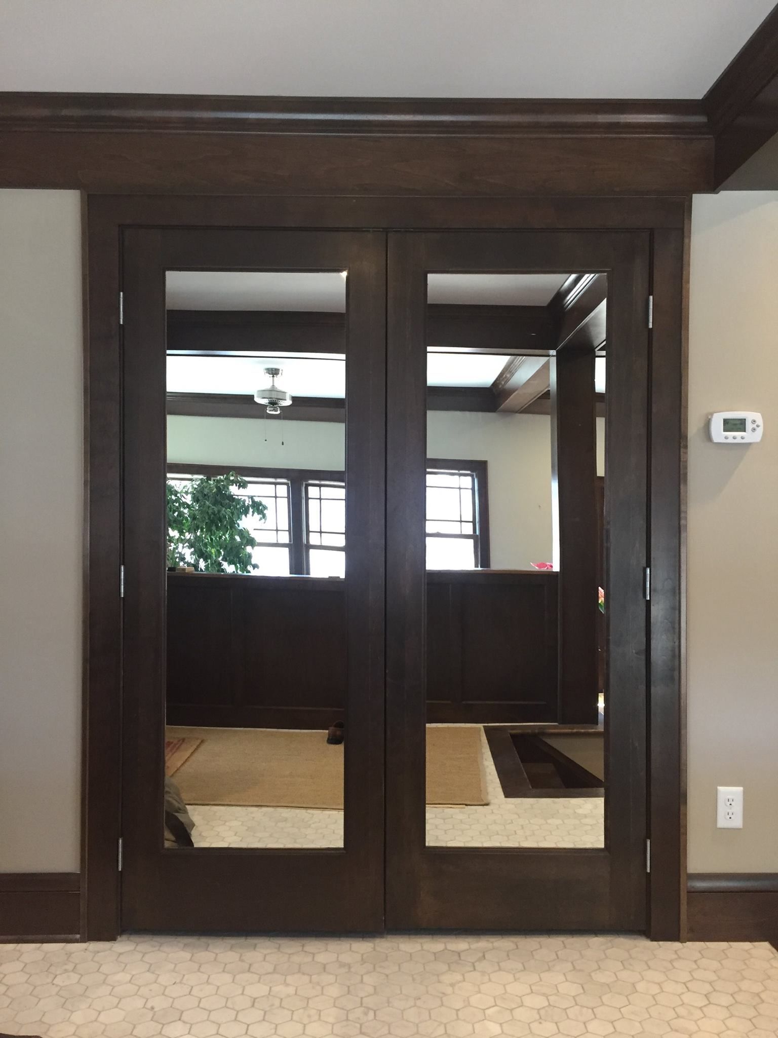 A pair of mirrored doors leading to a living room