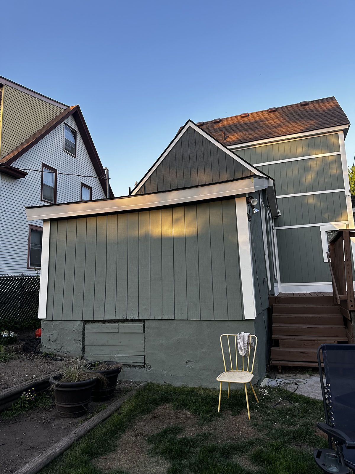 A small house with a chair in front of it.